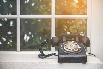 Old black phone with dust and scratches, retro style concept 