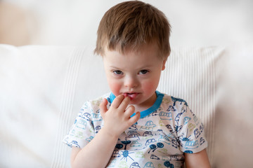 Wall Mural - Portrait of cute small boy with Down syndrome