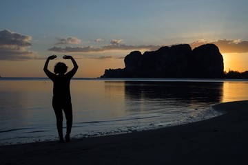 Wall Mural - silhouette of a woman at sunset