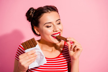 Canvas Print - Close-up portrait of nice cute charming attractive winsome lovely glamorous fascinating feminine girl in striped t-shirt biting tasting eating desirable favorite dessert isolated over pink background
