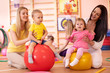 © Oksana Kuzmina - Mothers with babies doing exercises with gymnastic ball in gym. Concept of caring for the child's health