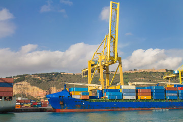 Cargo ship and cranes in the dockyard of Barcelona, Spain