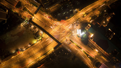 Poster - Aerial view of highway junctions shape letter x cross at night. Bridges, roads, or streets in transportation concept. Structure shapes of architecture in urban city, Kuala Lumpur Downtown, Malaysia