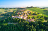 Fototapeta Natura - aerial view of a little town located in the italian countryside hills