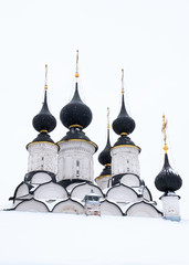 View of the black domes of the white church in winter