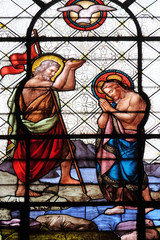 Baptism of the Christ, stained glass window in the Basilica of Notre Dame des Victoires in Paris, France 