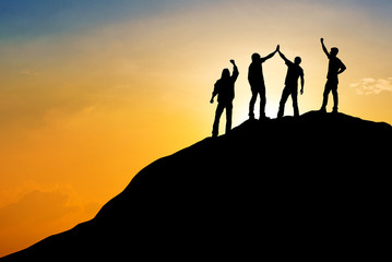 Wall Mural - Group of people on peak mountain with sunset background ,team work success business  winner concept