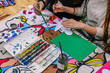 © Антон Брехов - Girls paint colors at the table. In the hands of the brush. Color palette with paints