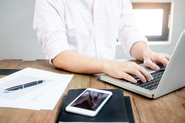 young caucasian man working at home planning work writing note on some project with his laptop on a desk, strartup business, e learning concept