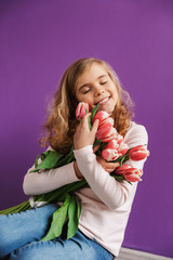 Sticker - Portrait of a smiling little girl holding bouquet of tulips