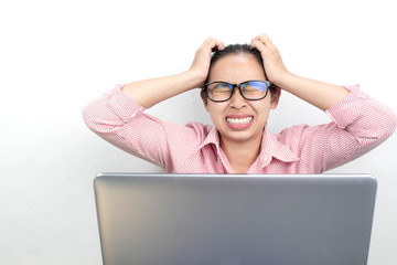 Close up portrait of stressed Asian woman, wearing glasses, looking tablet with seriously face and have headach symtom, sitting over white background with copy space.