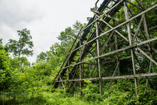 Abandoned Bridge Amidst Trees Against Sky