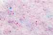Scented bath salt closeup background in pink and purple colors, top view