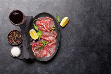 Wall Mural - Marbled beef carpaccio and red wine