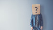 © oatawa - Man has Confused, Thinking, Question Mark Icon on Paper Bag, copy space.