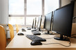 © Maren Winter - Empty computer room with monitors and keyboards in a row for pupils and students in a school computer lab
