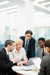 Wall Mural - Multi ethnic group of business people brainstorming project during meeting in office, copy space