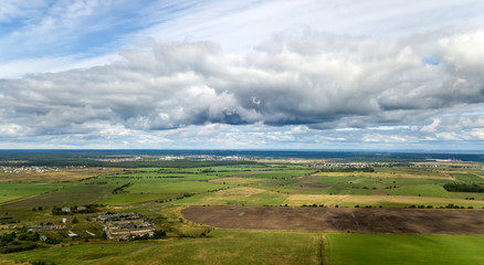 Wall Mural - drone view on the field with a green grass and the village in the distance...