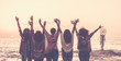 © simona - Vintage tones pictures of five women friends viewed from rear giving up hands for happiness in front ona sunset on the ocean and holding lights and a dreamcatcher for spiritual concept