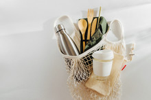 Mesh Market Bag With Bamboo Cutlery, Reusable Coffee Mug  And  Water Bottle. Sustainable Lifestyle.  Plastic Free Concept.