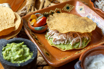 Mexican food. Tortilla toast with chicken and guacamole 