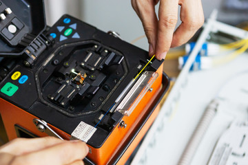 Fototapete - worker comunicate fiber optic cable at opto box. installing new network equipment
