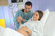 husband supporting woman during childbirth