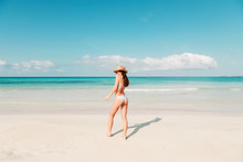 Spain, Mallorca, Rear View Of A Young Woman On Holidays Standing On The Beach