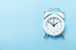 © Юлия Завалишина - Ringing twin bell vintage classic alarm clock Isolated on blue pastel colorful trendy background. Rest hours time of life good morning night wake up awake concept. Flat lay top view copy space