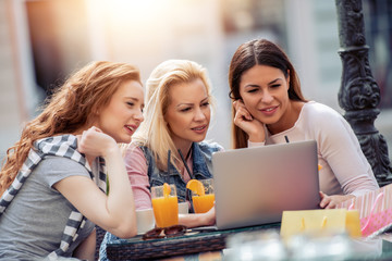 Canvas Print - Three young women in cafe after shopping