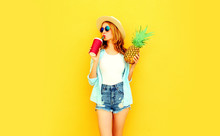 Pretty Young Woman Drinking Juice, Holding Pineapple In Summer Straw Hat, Sunglasses, Shorts On Colorful Yellow Background