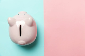 Saving investment budget wealth retirement financial money banking concept. Pink piggy bank isolated on blue and pink pastel colorful trendy geometric background. Flat lay top view copy space