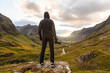 © Westend61 - UK, Scotland, Man looking at view with the Three Sisters of Glencoe mountains on the left and the A road in the middle of the valley