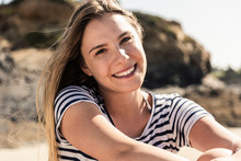 Portrait Of A Happy Young Woman On The Beach