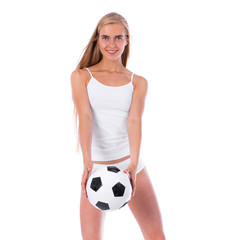 Young beautiful woman in white fitness clothing and soccer ball