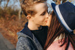 © Strelciuc - Side view portrait of a cute young caucasian couple kissing outside while dating in their vacation time traveling.