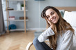 © BestForYou - Close-up portrait of beautiful happy woman looking at camera and smiling while sitting in a cozy chair.
