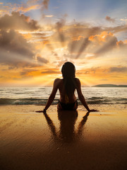 Poster - Silhouette of a woman on the beach at sunset