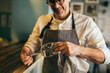 © cherryandbees - Middle aged barman polishing the wine glass in cafe bar