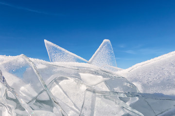 Wall Mural - Transparent baikal toros covered with hoarfrost against a blue sky