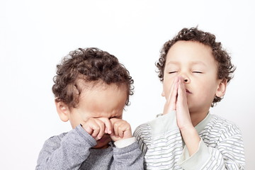 Wall Mural - little boy praying to God stock image with hands held together with closed eyes  stock photo