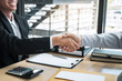 © Ngampol - Handshake after finishing conversation Businessman sending a resignation letter to employer boss in order to resign dismiss contract, changing and resigning from work concept