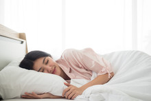 Beautiful Young Asian Woman Peacefully And Comfortable Sleeping On The  Bed With White Duvet Having Relaxing Happy Day Dream In The Morning Feeling The Soft Pillow, Copy Space