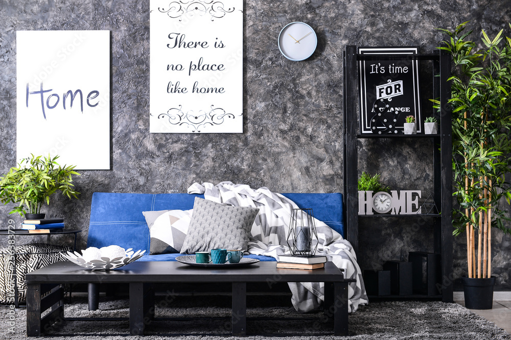 Interior of modern room with comfortable sofa and table
