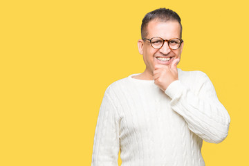 Middle age arab man wearing glasses over isolated background looking confident at the camera with smile with crossed arms and hand raised on chin. Thinking positive.