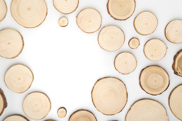 Wall Mural - Pine tree cross-sections with annual rings on white background. Lumber piece close-up shot, top view.