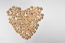 Alphabet Letters On Wooden Square Pieces Forming Heart Shape