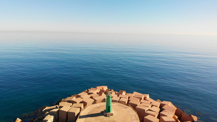 Wall Mural - Aerial drone view of a breakwater and a lighthouse in Denia port, Spain