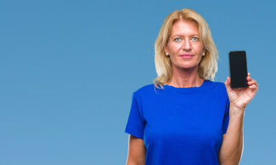 Poster - Middle age blonde woman showing blank screen of smartphone over isolated background with a confident expression on smart face thinking serious