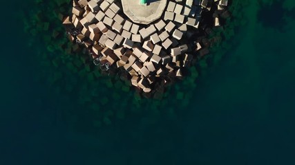 Wall Mural - Aerial drone view of a breakwater and a lighthouse in Denia port, Spain